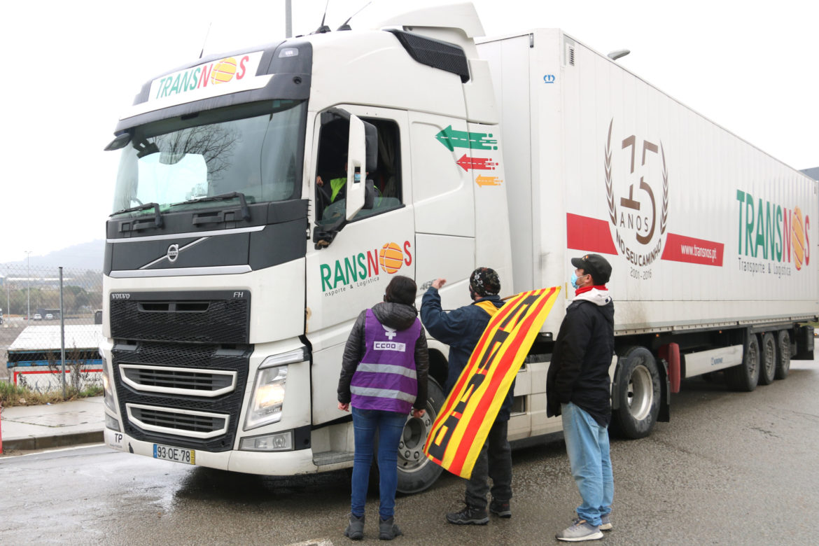 Un grup de treballadors aturant un camió a l'accés a la planta d'Oysho Logística a Tordera. Foto: ACN - Albert Segura Lorrio